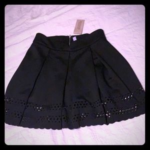 Black cocktail skirt with cut out trim